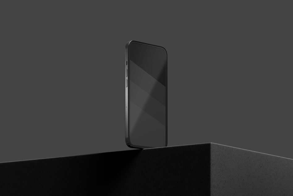 Black smartphone mockup standing on concrete platform against dark background