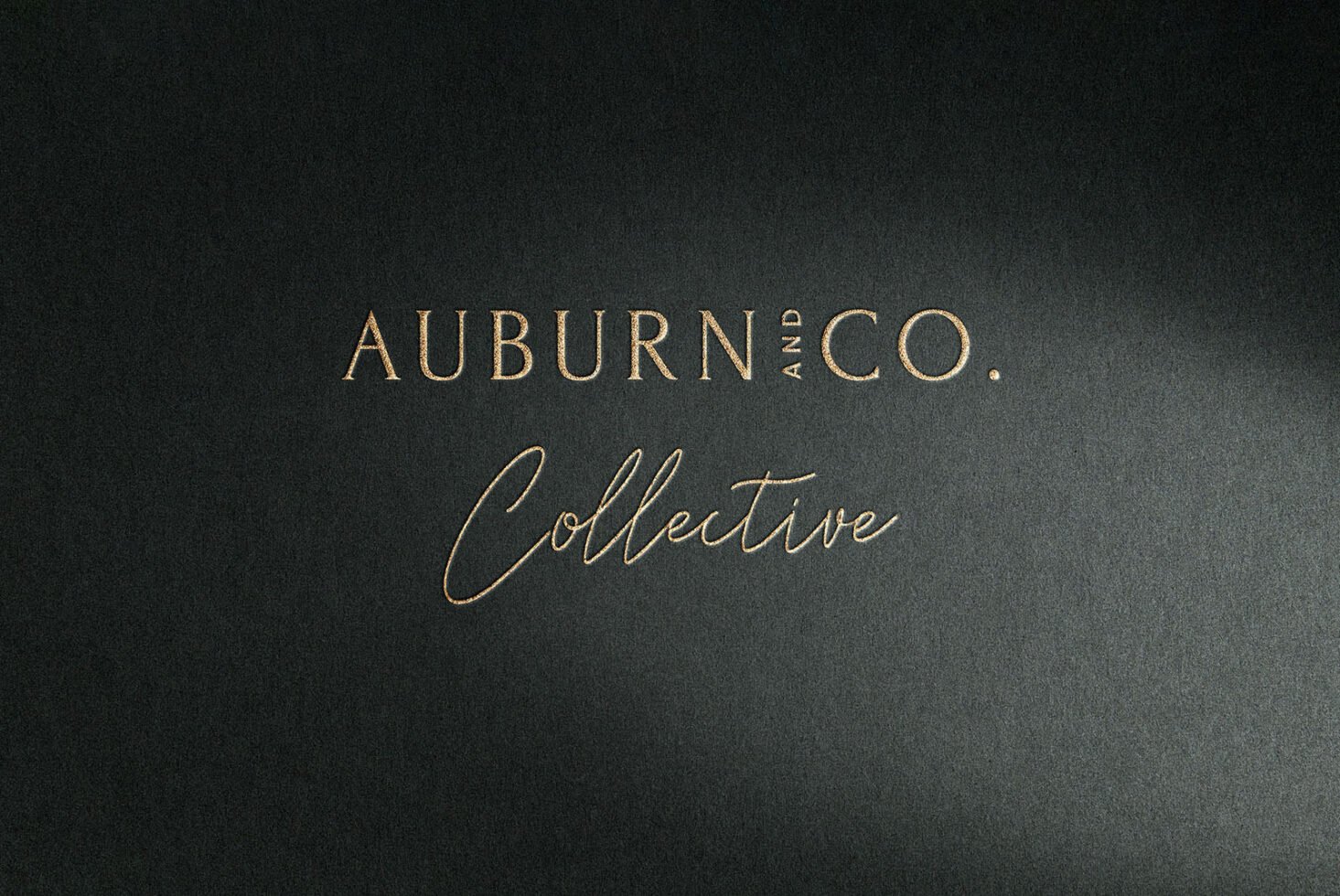 Elegant black and gold typography mockup for branding design featuring stylish serif and script fonts promoting Auburn and Co. Collective on textured paper.