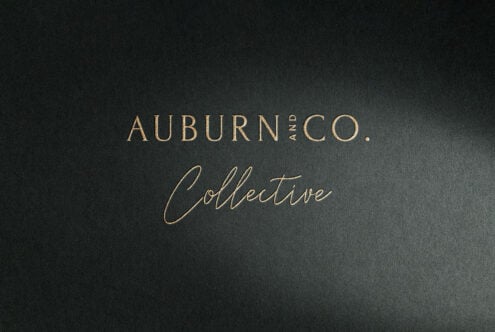 Elegant black and gold typography mockup for branding design featuring stylish serif and script fonts promoting Auburn and Co. Collective on textured paper.