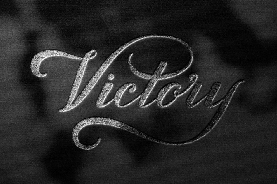 Flowing script lettering rendered in chalk on dark textured surface