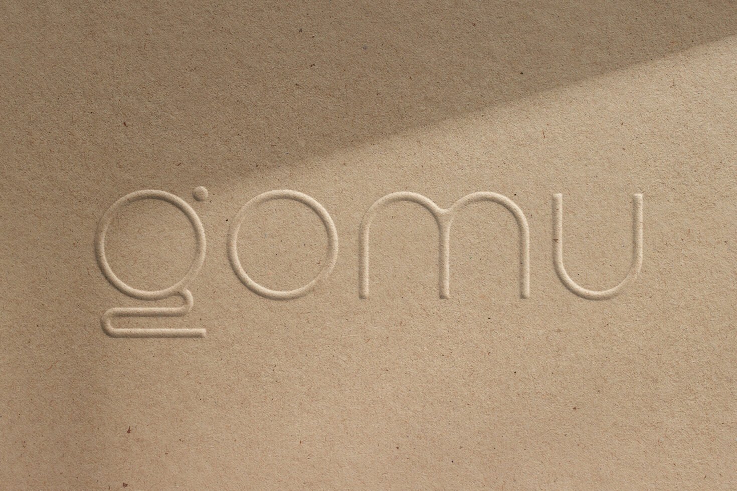 Embossed logo mockup on textured brown paper background with modern minimalist typeface for branding identity design presentation asset for designers