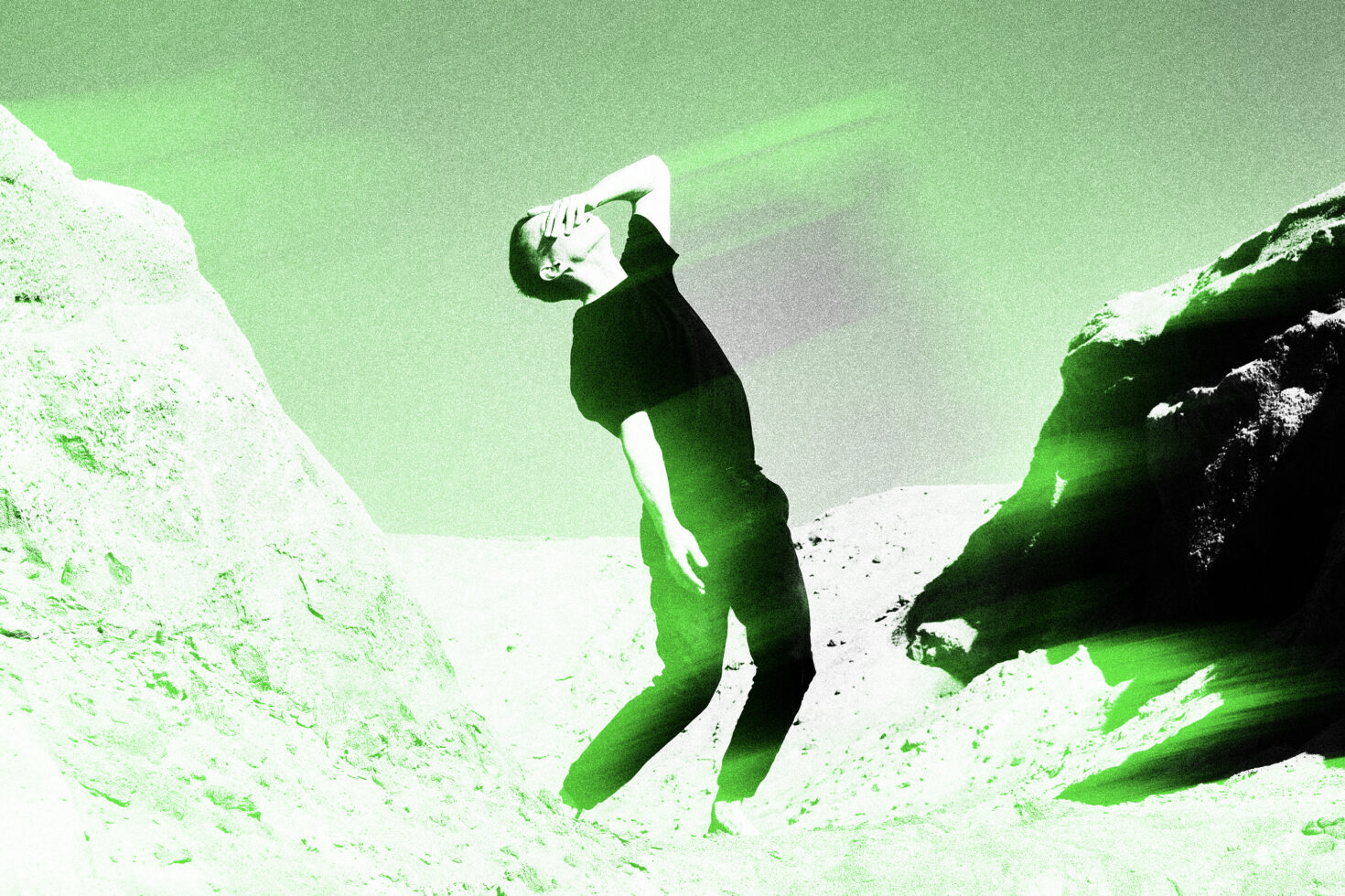 Person jumping between textured cliffs with lime green light effect overlay