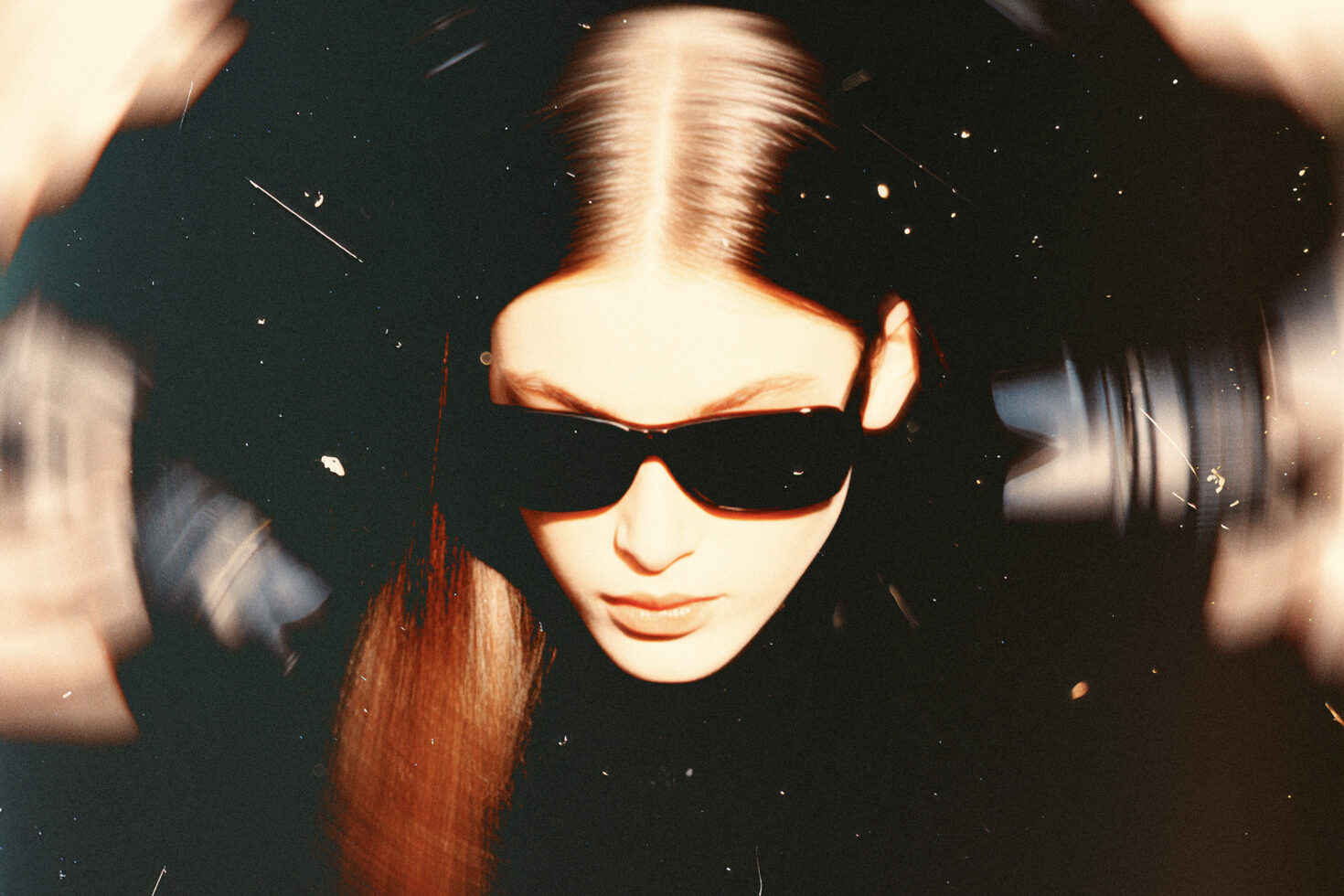 Close-up of a person in sunglasses with blurred motion effect and grainy texture ideal for graphic design projects and creative templates bold style