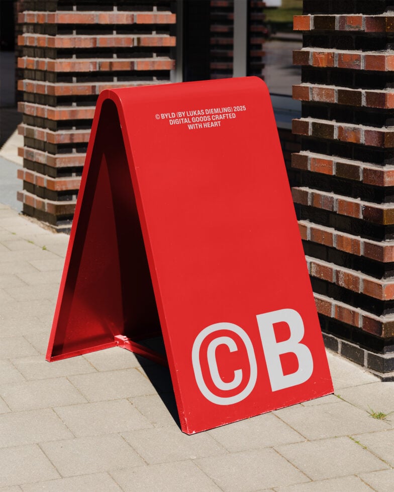 Red sidewalk sign mockup with bold lettering CB against brick wall. Ideal for showcasing outdoor advertising design in urban settings. Graphic design asset.