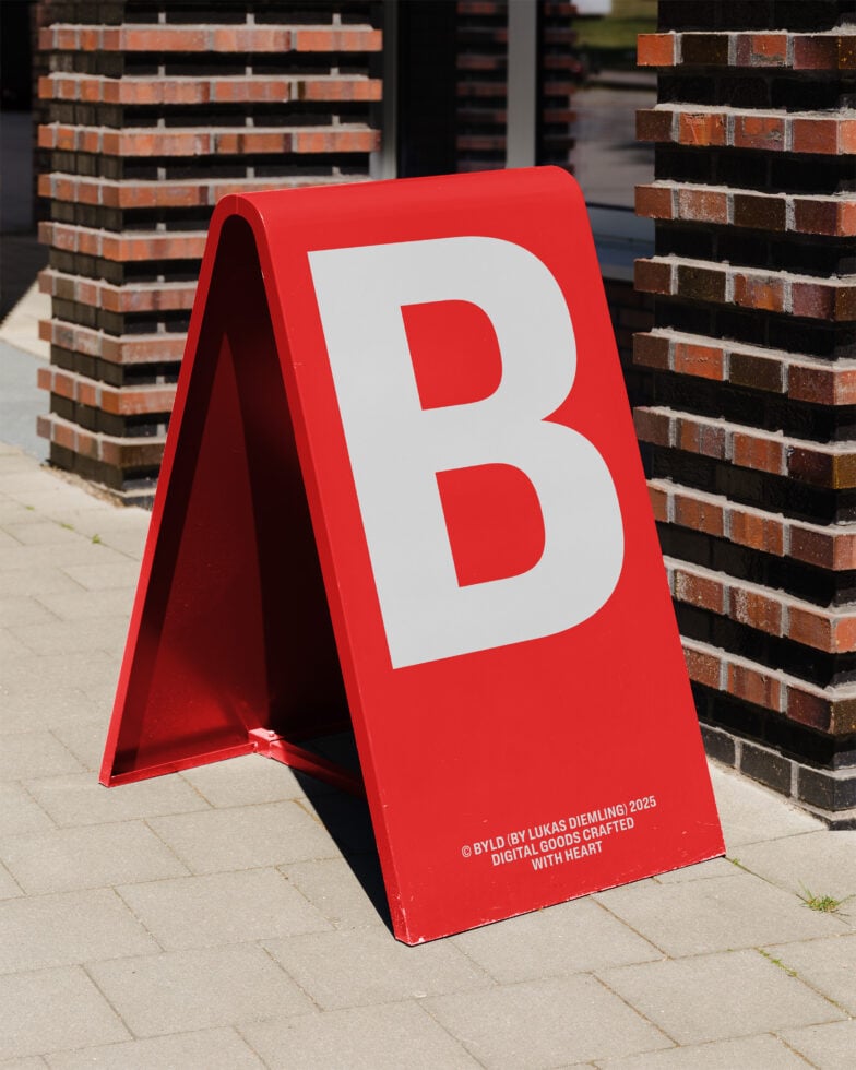 Red A-frame signboard with large white letter B. Perfect for urban outdoor advertising mockup. Ideal for designers seeking customizable templates.