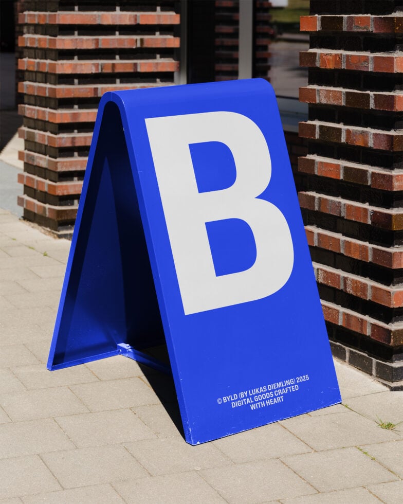 Blue A-frame sidewalk sign with large white letter B. Ideal for mockups and branding presentations. Street setting with brick wall background.