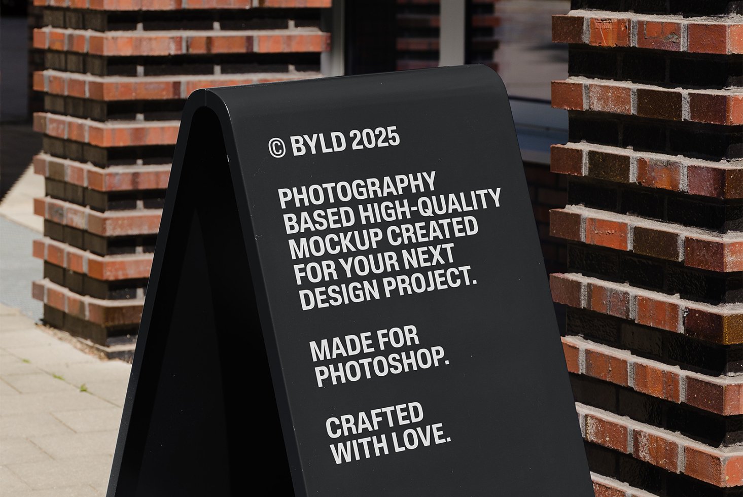 High-quality Photoshop mockup of a black sidewalk sign, ideal for design projects. Perfect for showcasing typography and graphics. Crafted with care.