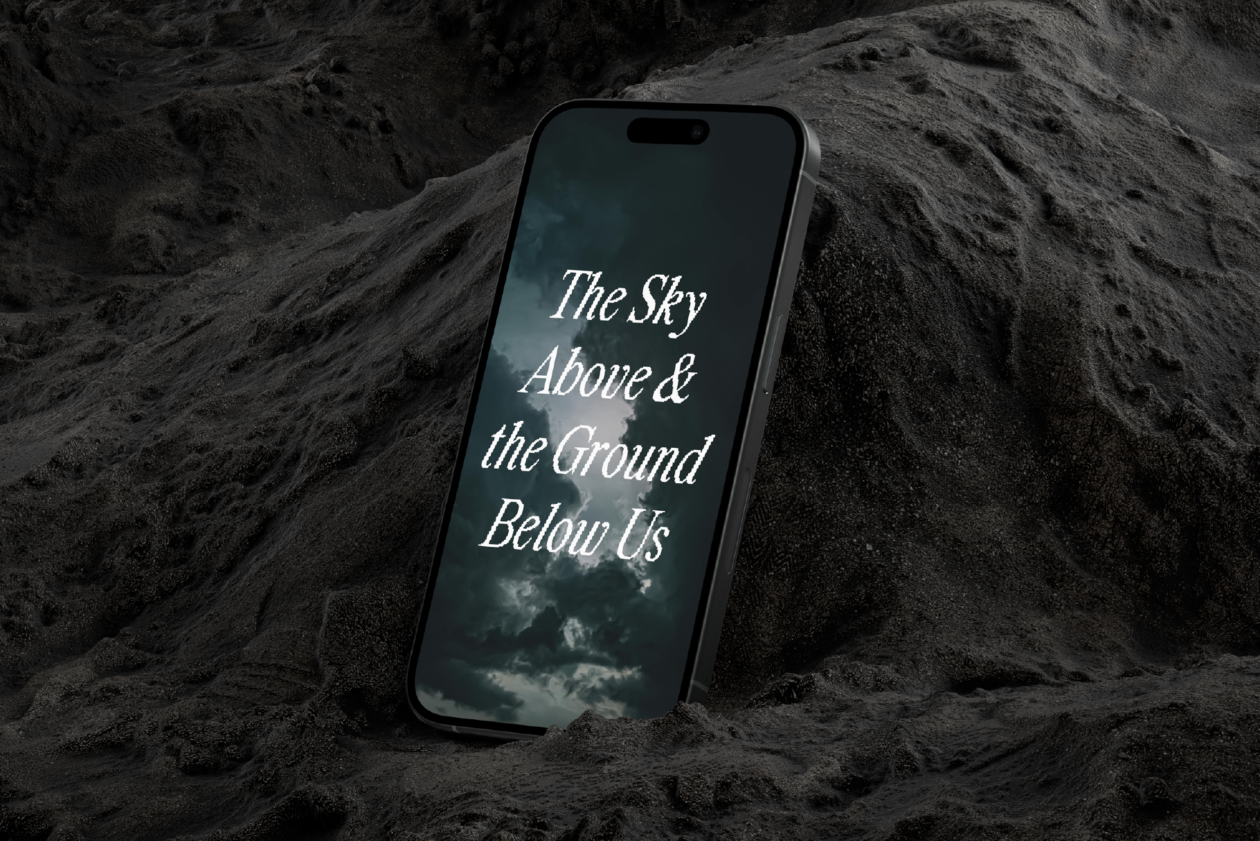 Smartphone mockup with dramatic sky wallpaper and text resting on dark sandy surface ideal for designers seeking unique digital art assets and templates.