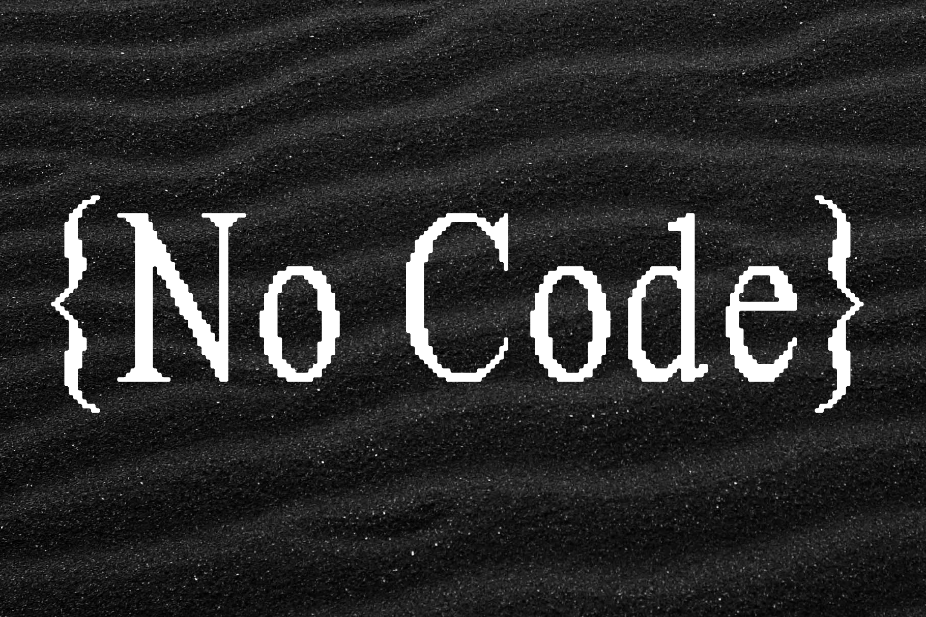 Black sand background with the words No Code in pixelated white font. Ideal for technology graphics and templates focusing on no-code design concepts.