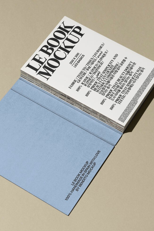 Book mockup with blue cover and detailed typography for graphic designers. Ideal for showcasing book designs in presentations. Mockup resource.