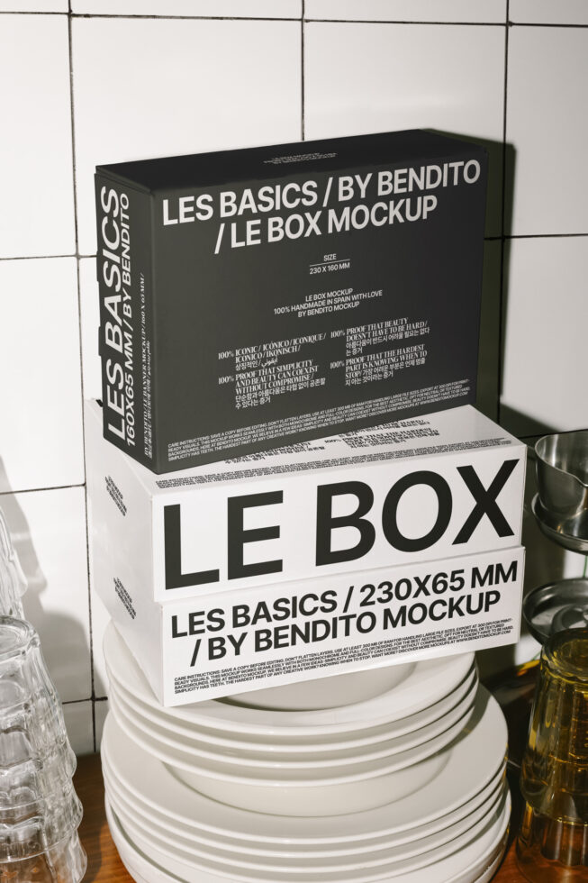 Box mockup design in kitchen setting featuring stack of plates and glassware. Ideal for showcasing packaging designs. Keywords: mockup, packaging, design.