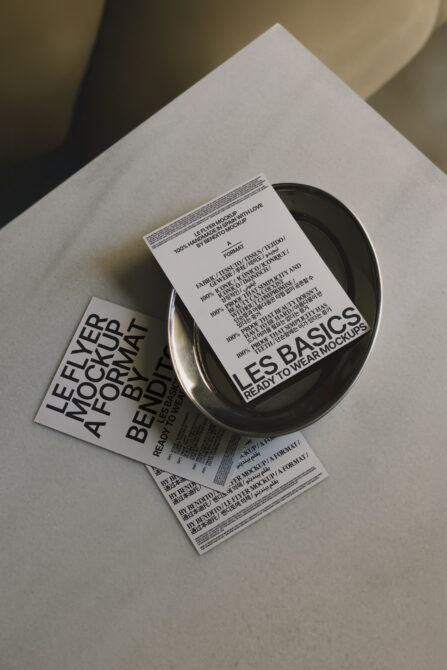 Flyer mockup set on a sleek plate and surface. Fashion-forward design ideal for showcasing unique templates or graphics in stylish branding projects.