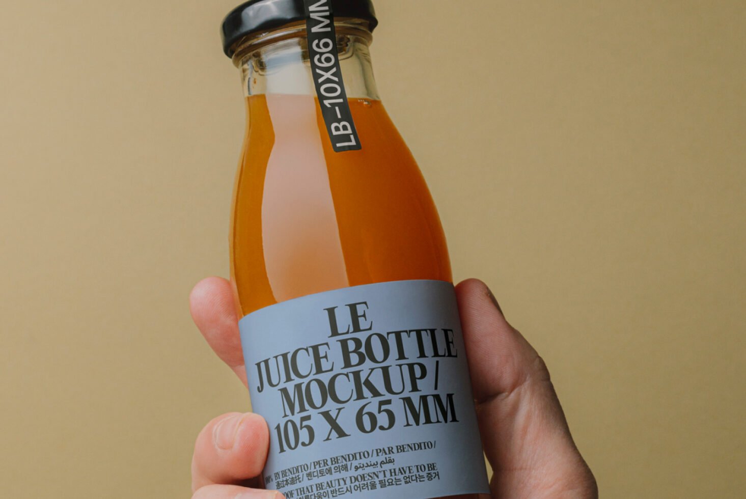 Juice bottle mockup held by a hand with detailed label. Perfect for designers seeking packaging templates, product presentation, and branding projects.
