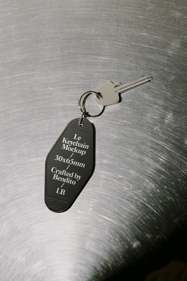 Keychain mockup on brushed metal surface featuring customizable design crafted by Bendito. Ideal for designers seeking graphics, templates, and mockups.