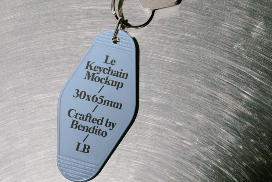 Light blue motel-style keychain tag with black text hanging from cord