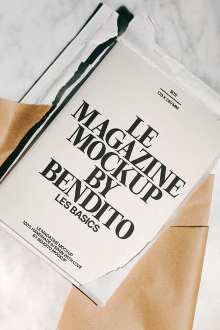 Magazine mockup with cream cover on kraft paper, marble flatlay view