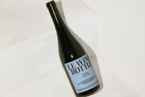 Dark wine bottle mockup with minimalist label on a white background ideal for designers branding templates product presentation mockups digital assets