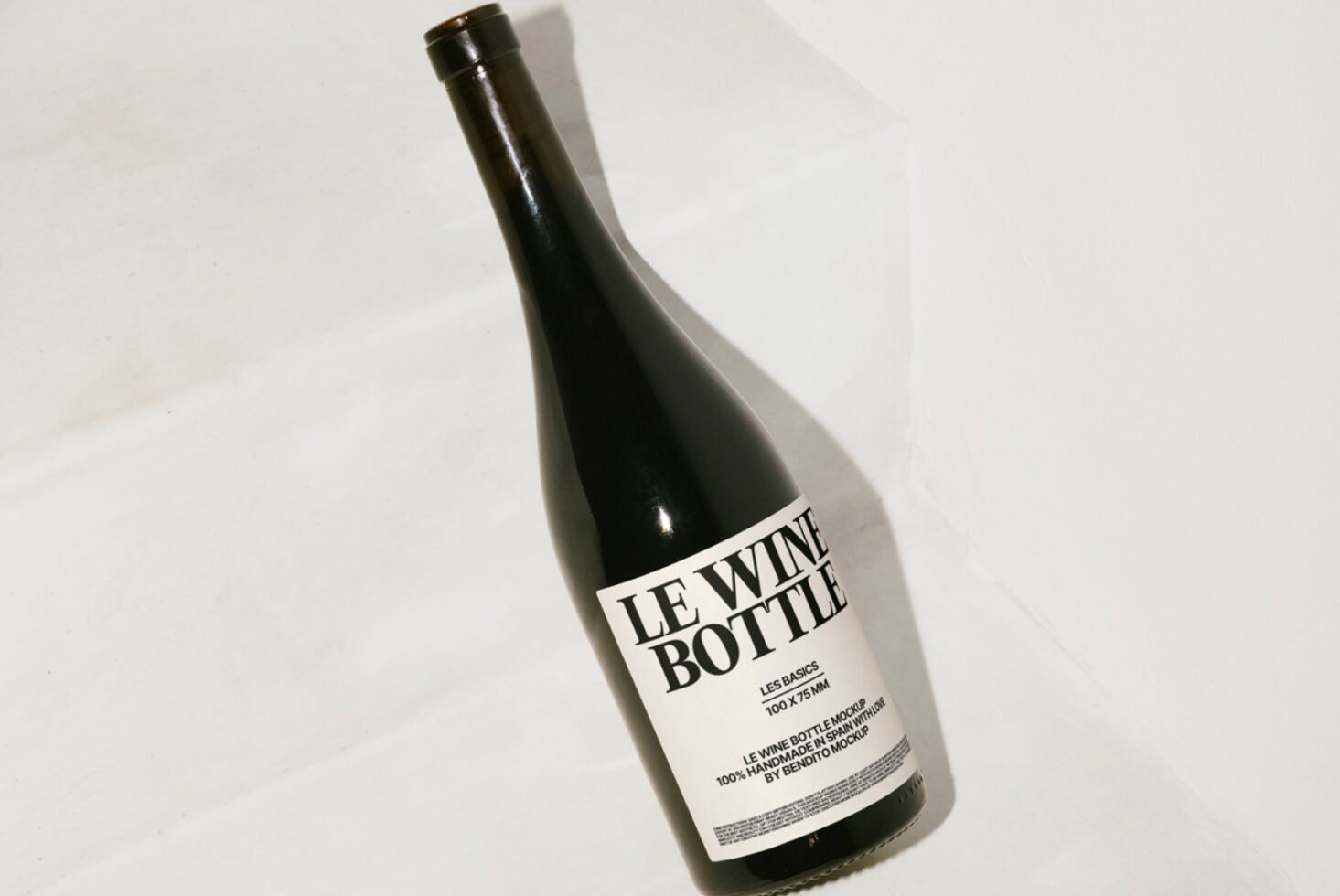 Standing wine bottle mockup with minimalist label on neutral background. Ideal for product design presentations. Keywords: wine, bottle, mockup, design.