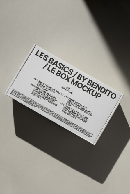 White box mockup tilted with sharp shadow on neutral surface
