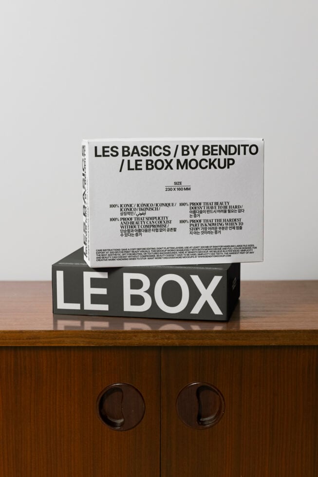 Stacked boxes showing white lid on black base with minimal typography design