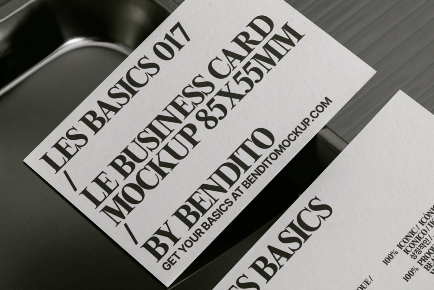 Business card mockup with bold typography on textured paper, featuring 85x55mm design by Bendito, ideal for graphic designers seeking sleek templates.