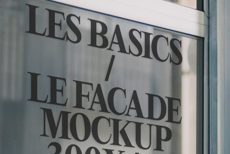 Close up of store window with dark serif type Les Basics facade mockup lettering