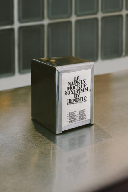 Napkin stack mockup 80x135mm with cream label on concrete