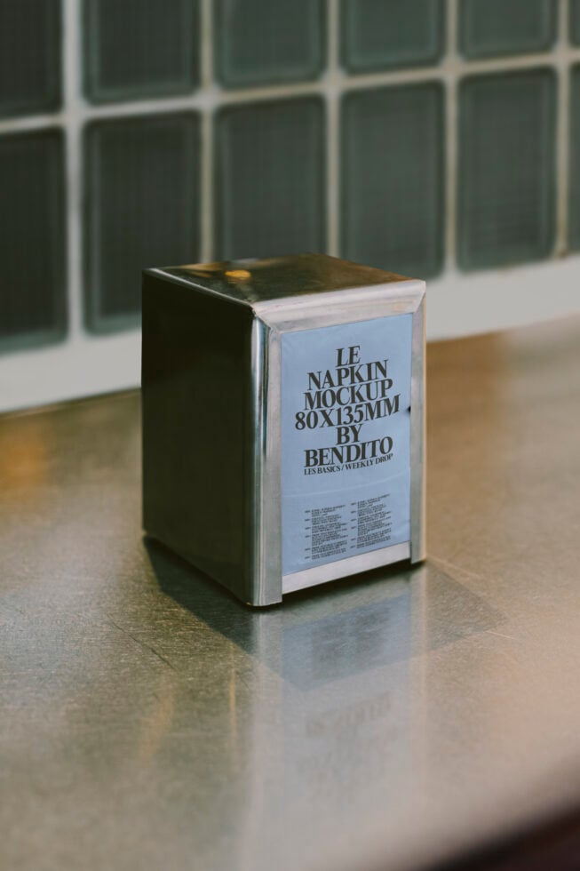 Napkin holder mockup on reflective surface perfect for designers creating realistic restaurant or cafe presentations high-quality graphics digital assets