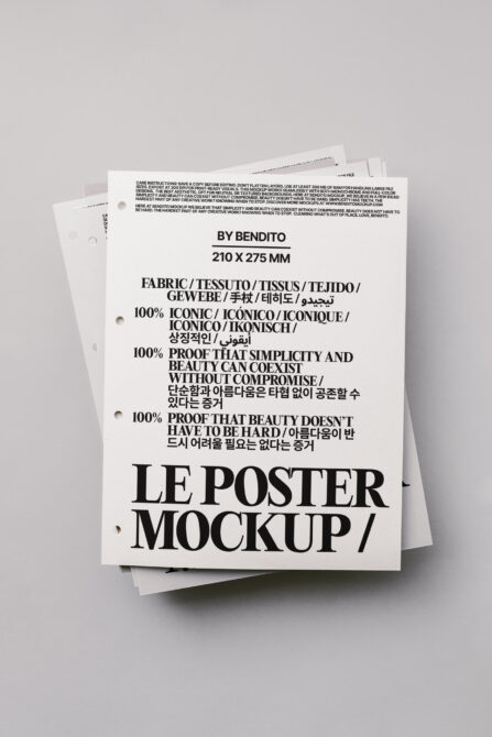 Stacked white poster mockup with hole punches in natural light