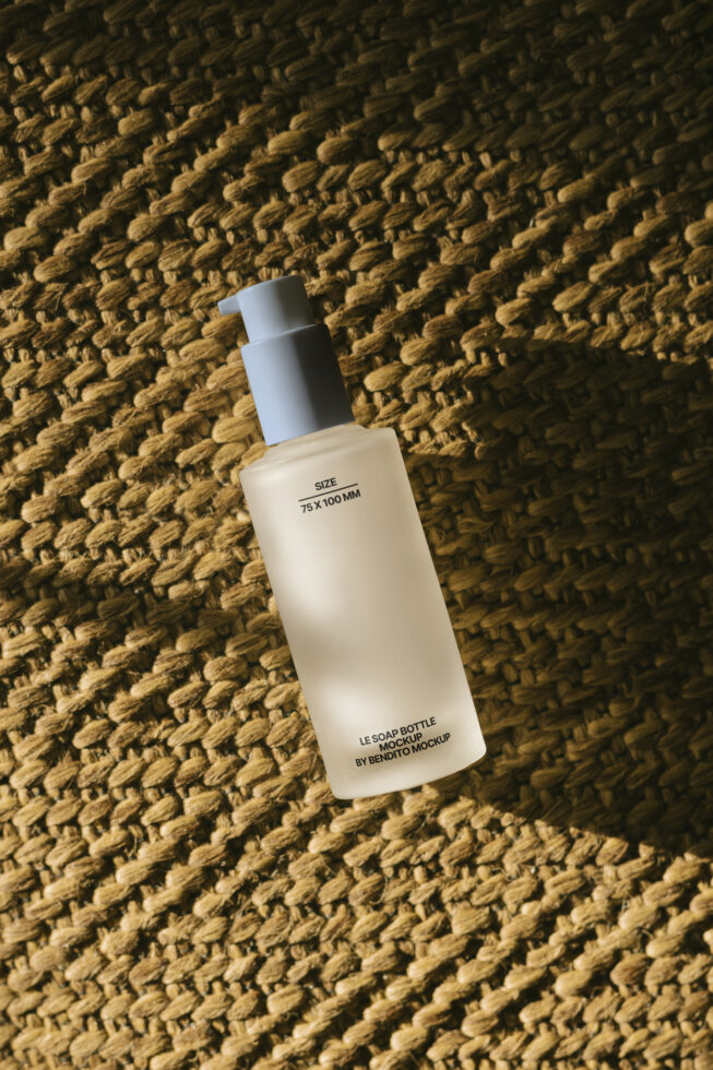 Soap bottle mockup on woven textured background ideal for showcasing branding and packaging designs. Perfect for designers seeking realistic product visuals.