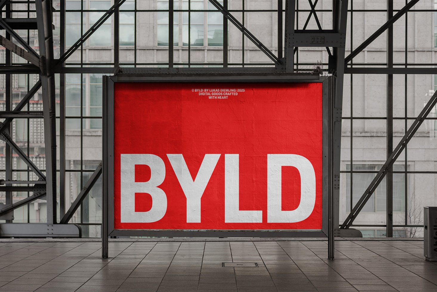 Large red billboard in urban setting displaying bold white text BYLD. Perfect for mockup designs and advertisement presentations. Industrial background.