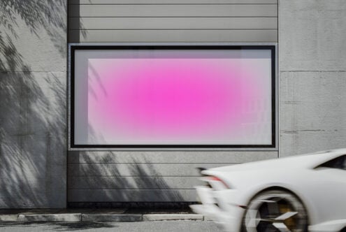 Contemporary wall mockup with pink gradient frame outdoors sunlight shadowing an adjacent surface car motion blur fits under templates for designers
