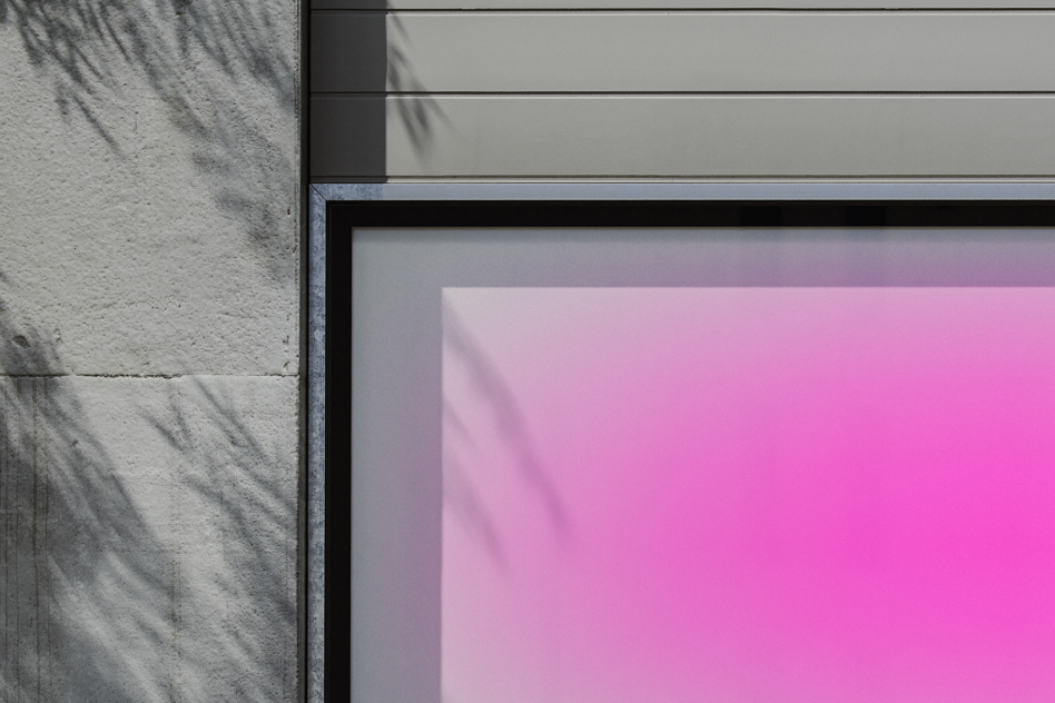 Mockup of a framed display with pink gradient poster on a textured concrete wall. Minimalist design, suitable for presenting artwork, graphics, or templates.