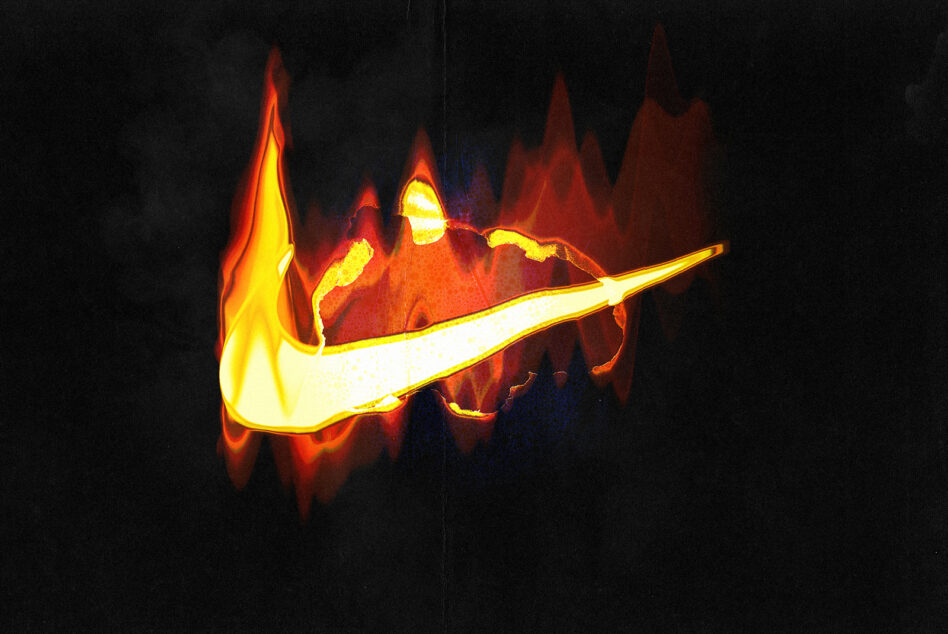 White glowing swoosh logo shape engulfed in yellow flames on dark background