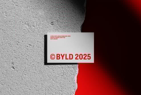 Business card mockup on textured surface with bold red text BYLD 2025. Perfect for designers seeking unique identity graphics and branding templates.
