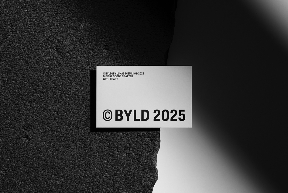 White business card showing BYLD 2025 copyright text on dark wall