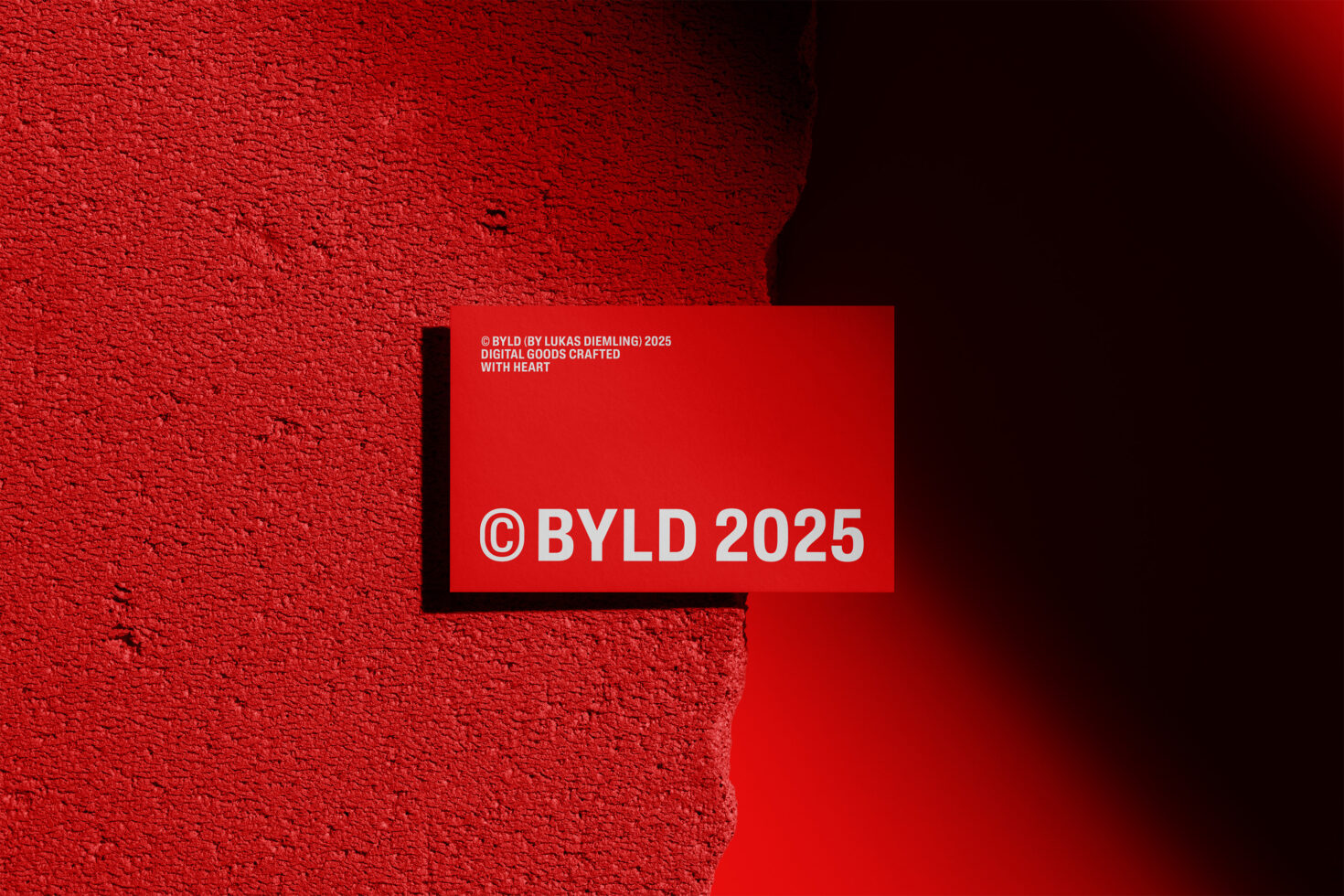 Red textured wall with an overlaying mockup card featuring bold text BYLD 2025 ideal for graphic designers seeking modern digital templates and assets.
