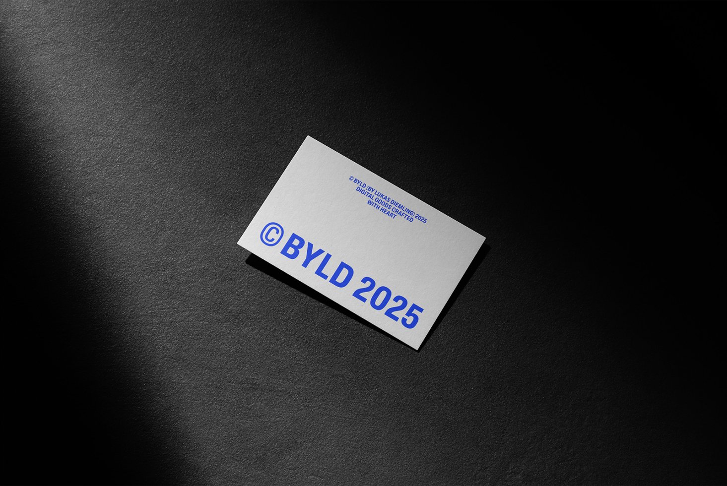 Business card mockup on dark textured background featuring minimalist design with bold blue typography, ideal for branding, templates, and graphic design projects.