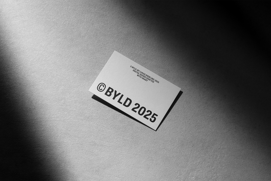 Black text on white business card mockup angled on gray textured surface