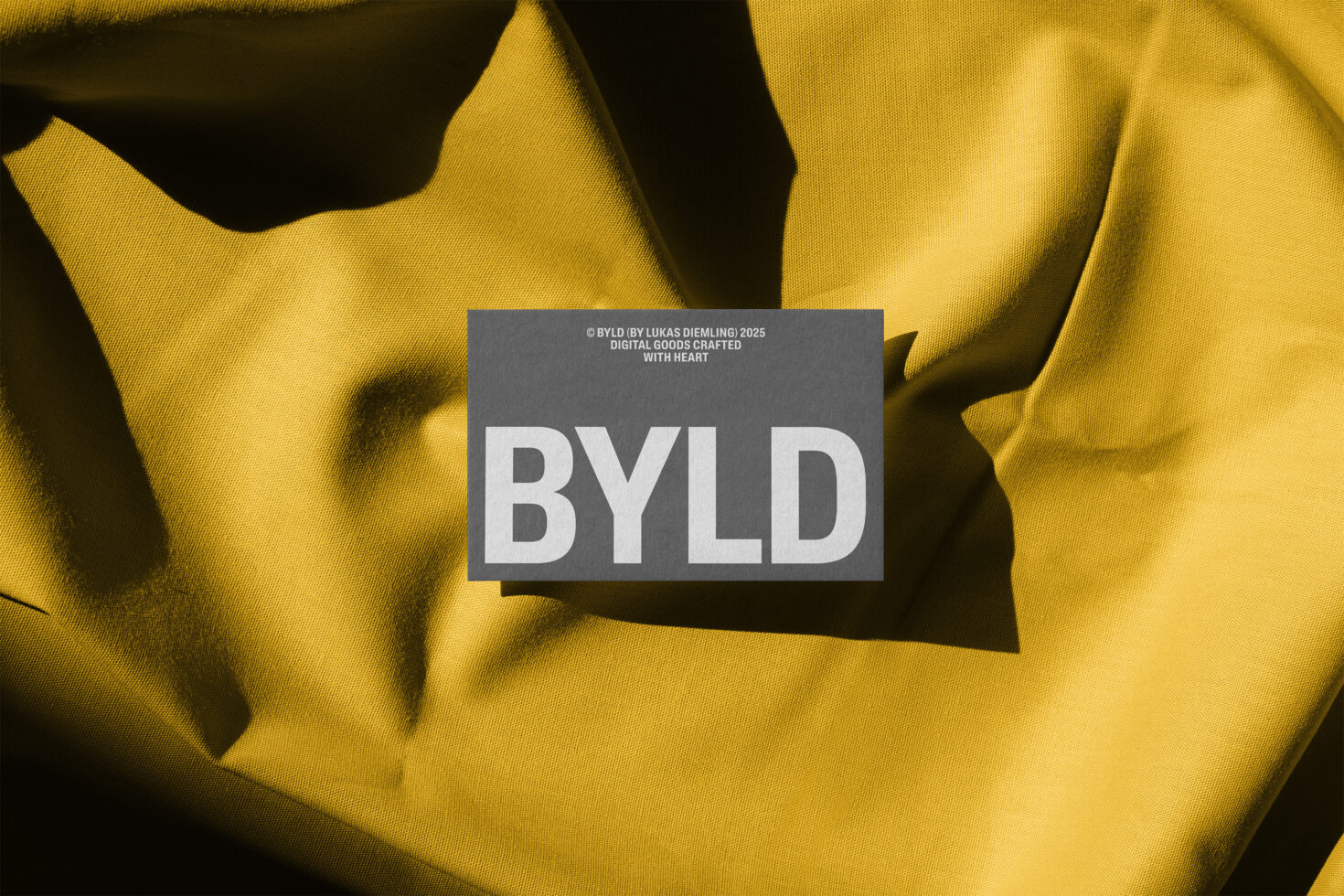 Bold BYLD branding over a textured yellow fabric. Ideal for designers seeking unique graphics, templates, or mockups. Enhance digital projects.