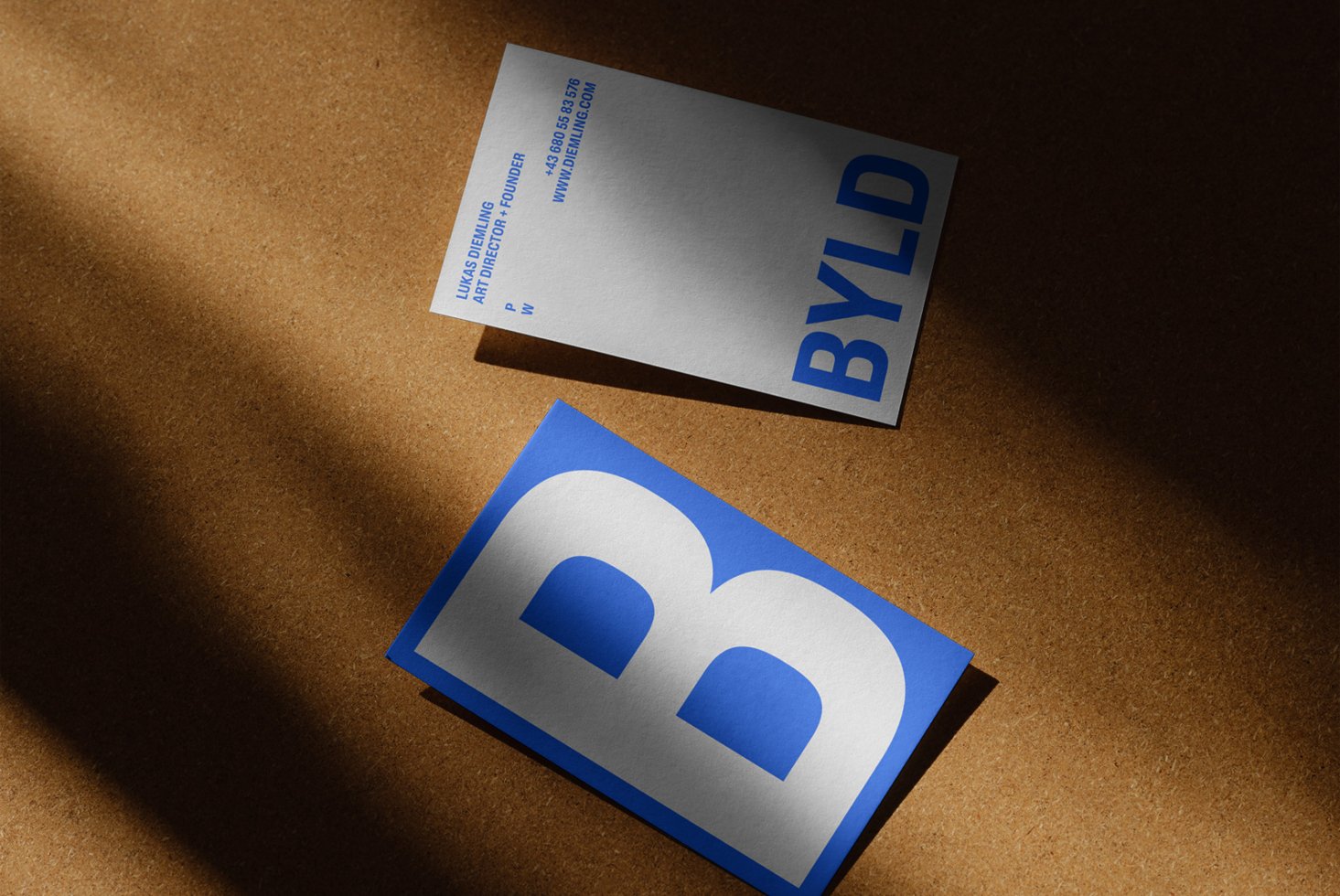 Business card mockup on corkboard featuring modern typography with blue and white design ideal for graphic designers and branding professionals templates