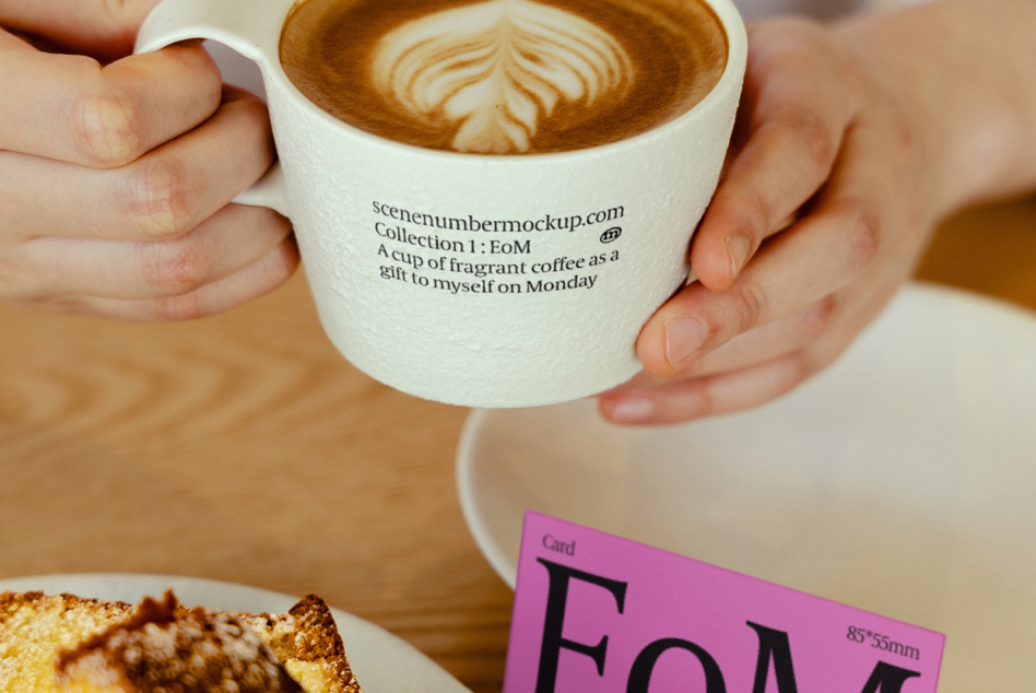 Hands holding white coffee cup with text overlay next to pink business card