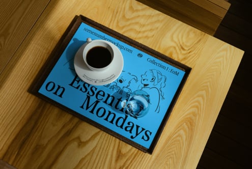 Top view of cafe table setup mockup with coffee cup and glass on blue placemat featuring illustrated design Essential Mondays; perfect for designers.