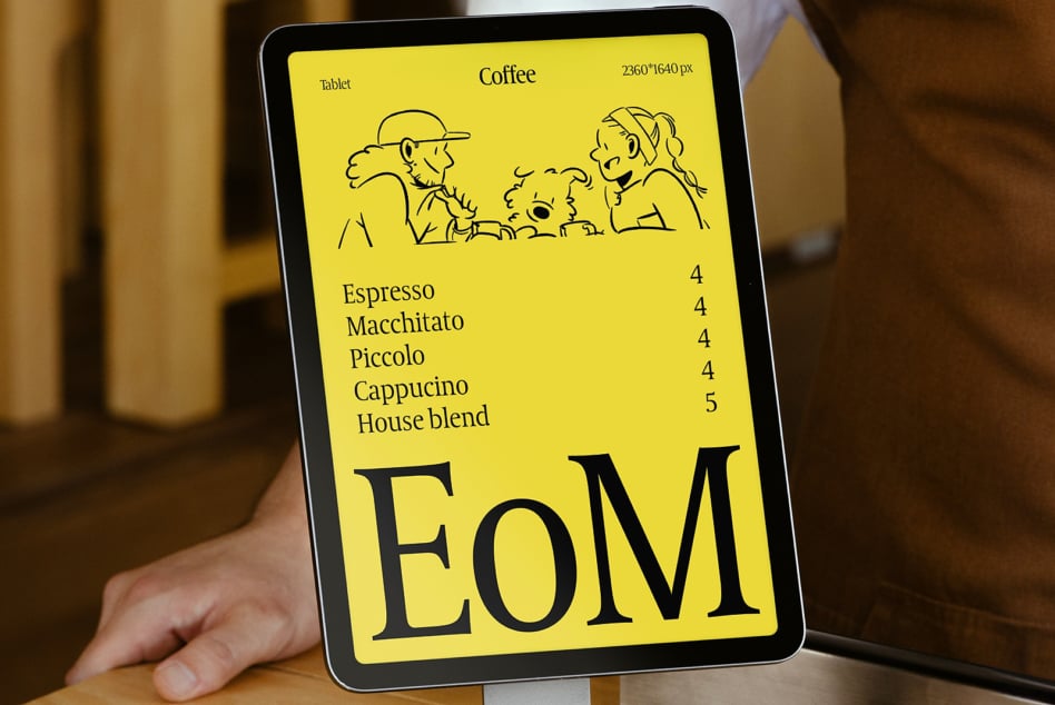Tablet screen displaying bright yellow menu with coffee drink options, EoM branding, line art people