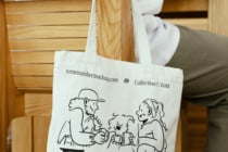 Canvas tote bag with cartoon characters drinking coffee, EOM branding visible