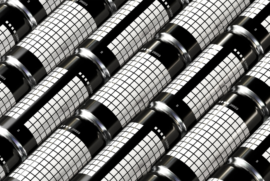 Close up of black cylindrical cans laid diagonal with grid pattern label wraps