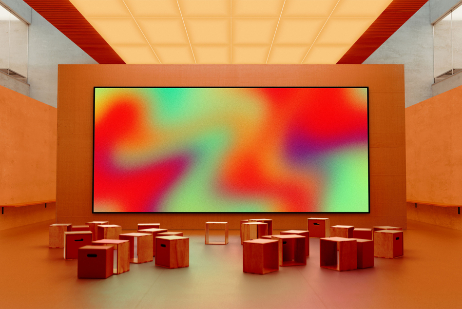 Horizontal screen with colorful gradient displayed on orange wall installation