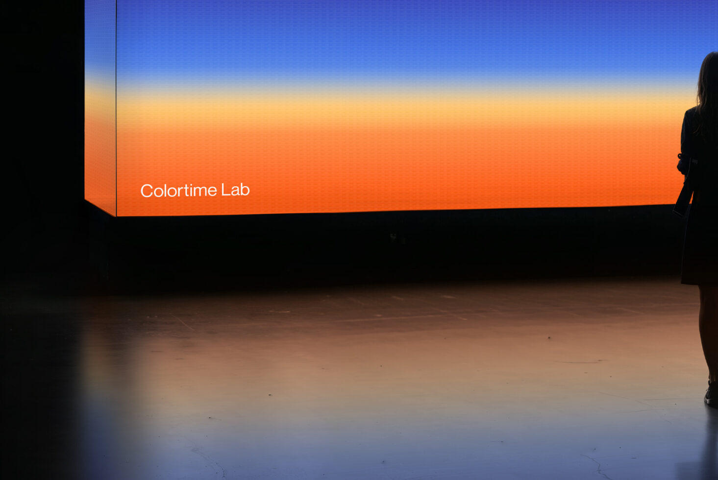 Colorful gradient display background by Colortime Lab with silhouette of person standing. Suitable for graphics projects, design mockups, templates.