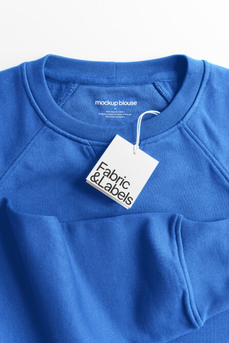 Bright blue crewneck sweatshirt with white hang tag mockup close-up