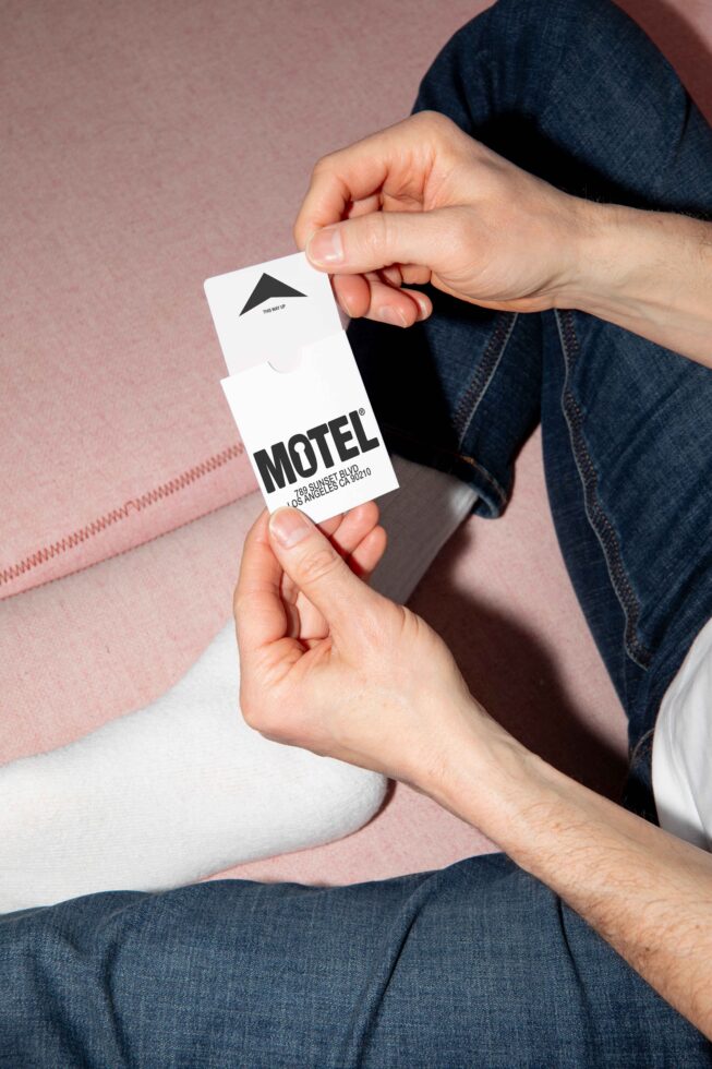 Hands holding a motel business card in minimalist design. Perfect for graphic designers seeking inspiration mockup templates creative assets branding.
